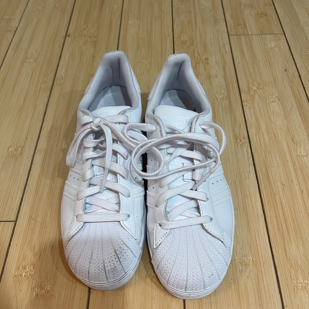 All white adidas superstar sneakers